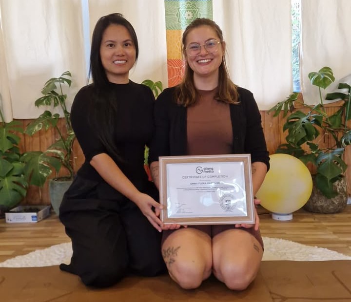 Giang with a 200-hour yoga teacher training graduate holding her certificate in Da Lat