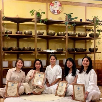 Singing bowl training students holding their certificates at the Da Lat studio